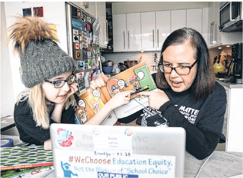 [Katie Lapham, an ESL teacher in Brooklyn, N.Y., records a video for one of her students with some help from her daughter Norah]